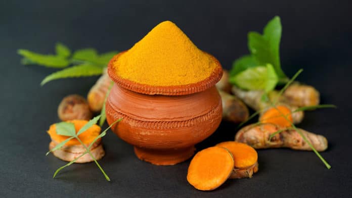 Image showing turmeric powder in clay pot