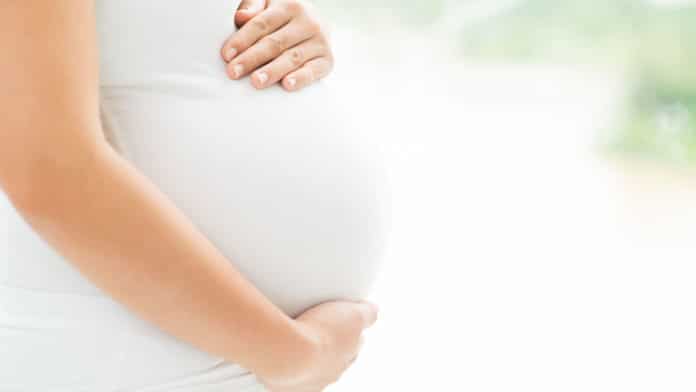 Image showing pregnant lady holding stomach