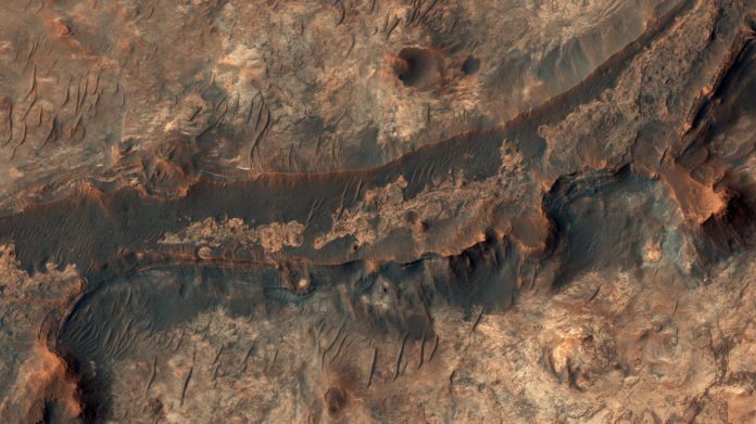 Billions of years ago, a river flowed across this scene in a Mars valley called Mawrth Vallis. A new study examines the tracks of Martian rivers to see what they can reveal about the history of the planet’s water and atmosphere.