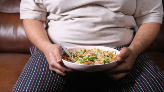 Image showing obese person having food