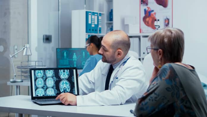 Doctor explayning how to reduce the risck of alzheimer for elderly patients, presenting a brain CT. Brain diagnosis, medical image CT, MRI or X Ray results in modern private hospital or clinic. Radiologist radiology healthcare system