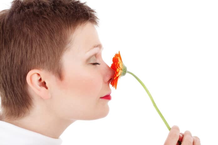 Image showing woman smelling flower