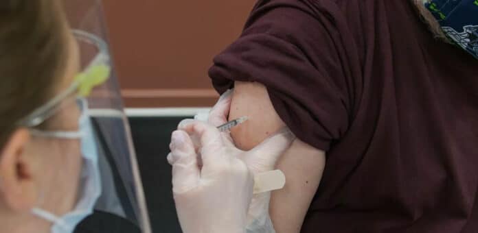Patient receiving a COVID-19 vaccination in their arm