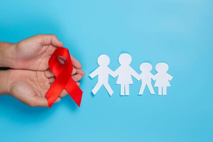 Image showing woman hand holding red ribbon hiv awareness concept world aids day.