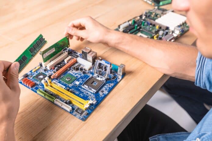 Image showing Engineer putting the ram memory module in motherboard