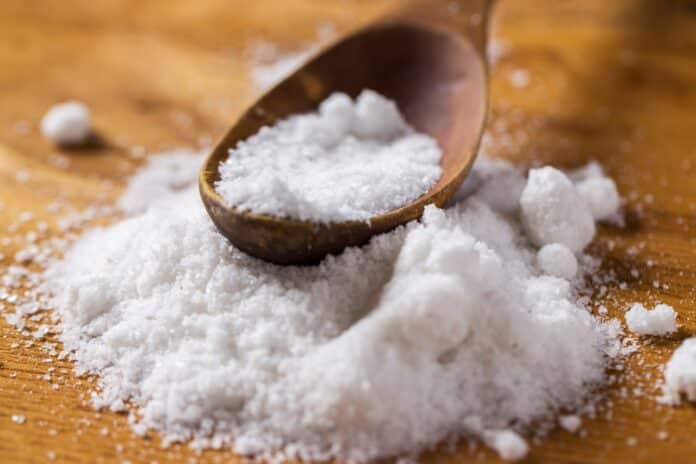 Image showing spoon and heap of salt on the table.