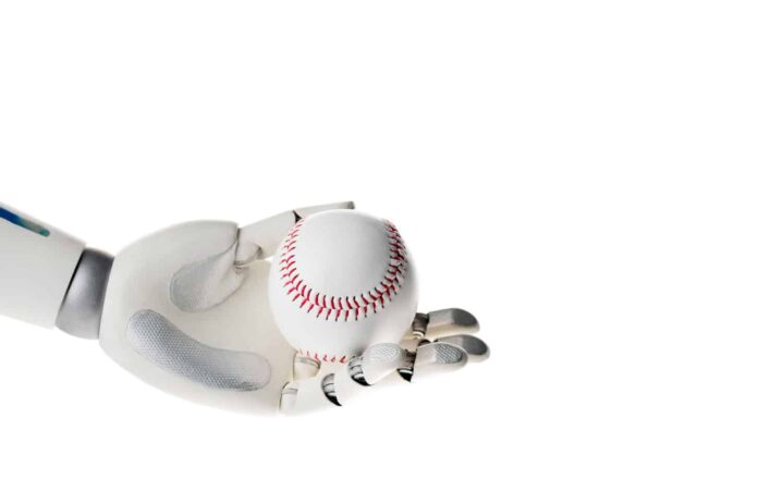 Robot hand holding white baseball ball isolated on white