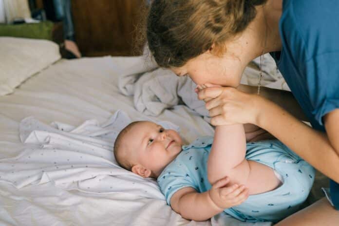 Image showing infant baby playing with her mother.