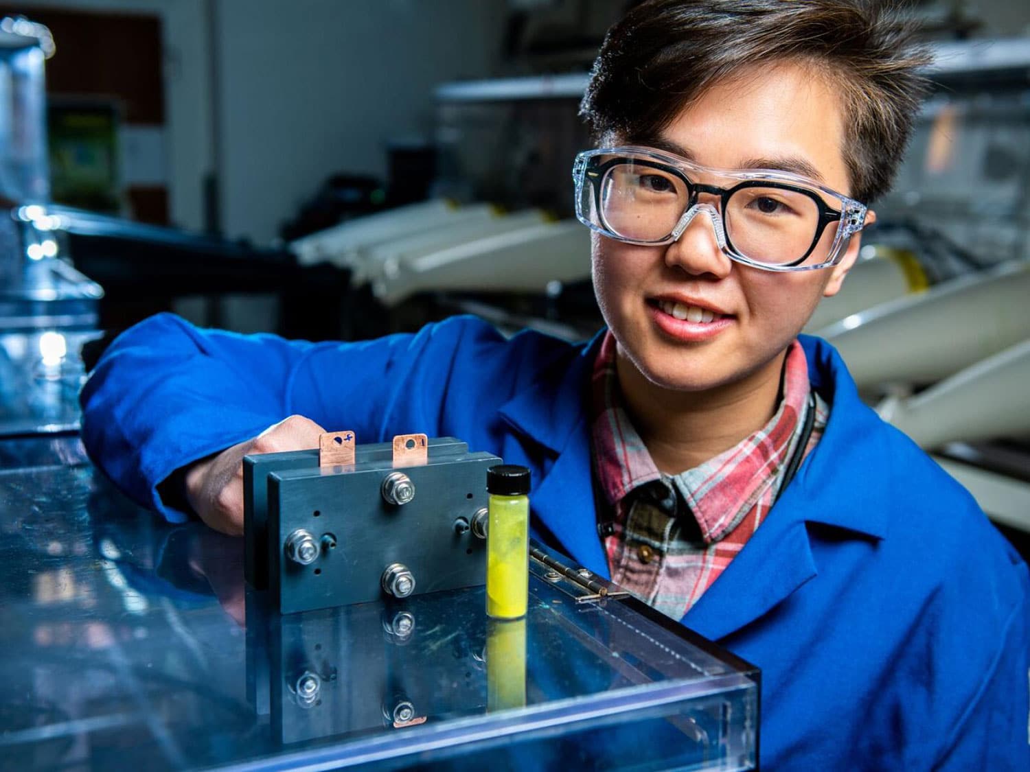 Researcher Ruozhu Feng poses with long-lasting grid energy battery.
