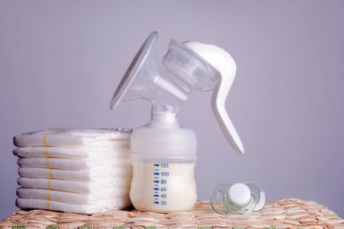 Image showing breast pump, diapers and baby pacifier.