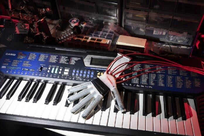 Image showing robo-glove-piano-newsdesk.