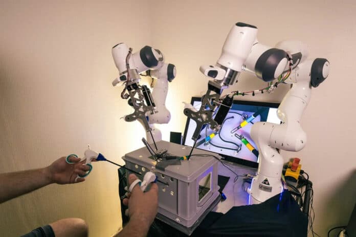 New system enables four-arm laparoscopic surgery by controlling two additional robotic arms via haptic foot interfaces.