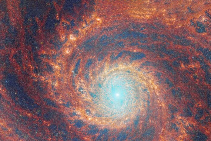 The graceful winding arms of the grand-design spiral galaxy M51 stretch across this image