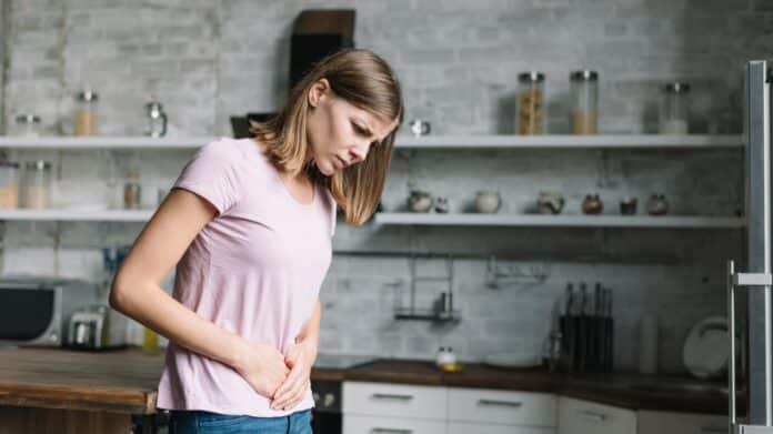 Woman having stomach pain because of chemical intolerance