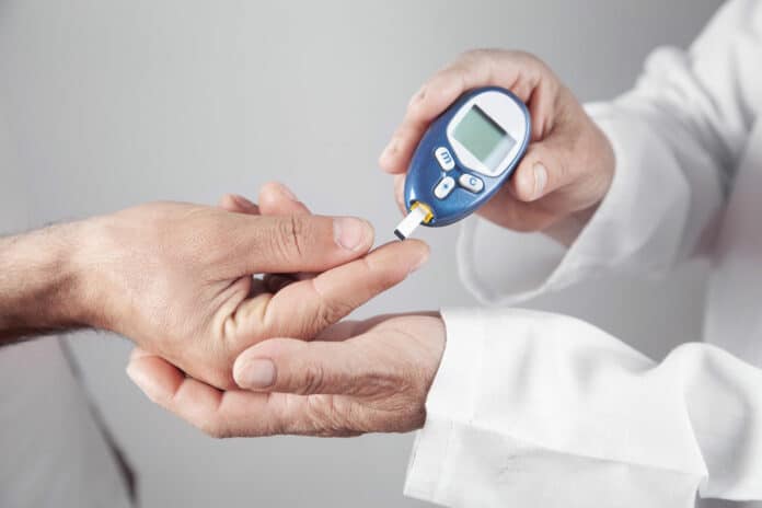 Doctor measuring patient glucose level