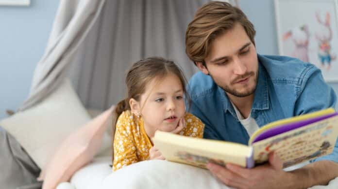 Image showing father reading book for daughter