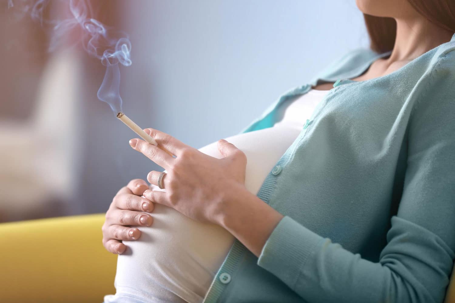 Image showing cigarette in pregnant lady's hand