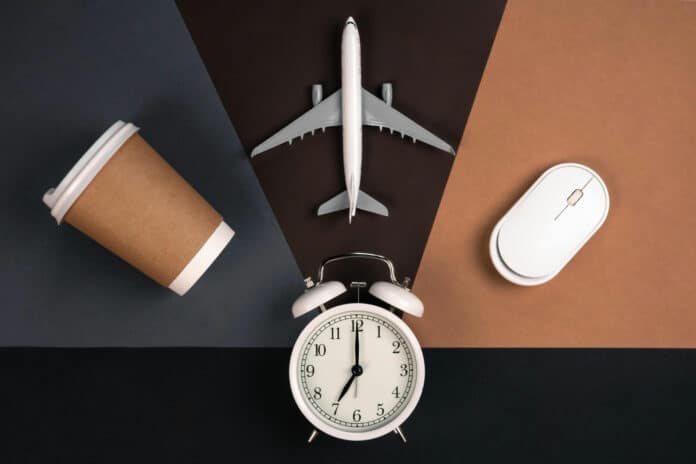 Image shows alarm clock computer mouse cup airplane paper.