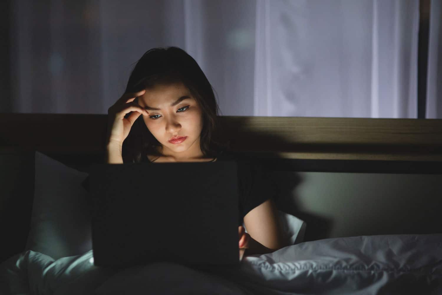 woman using laptop working late at night