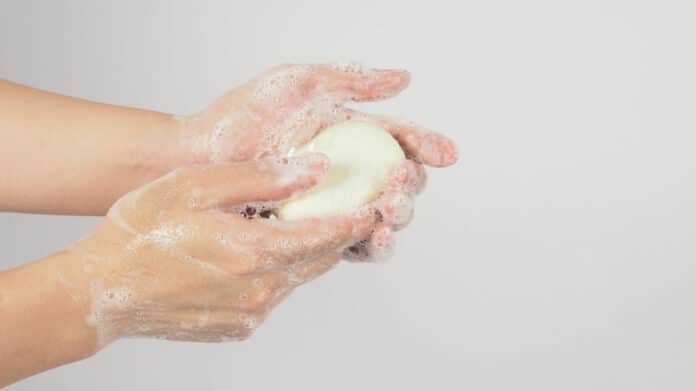 Hands washing gesture with bar soap.