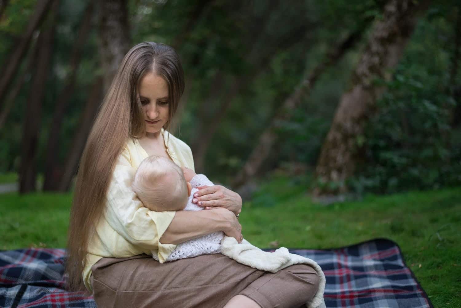 Image showing women breast feeding her child.