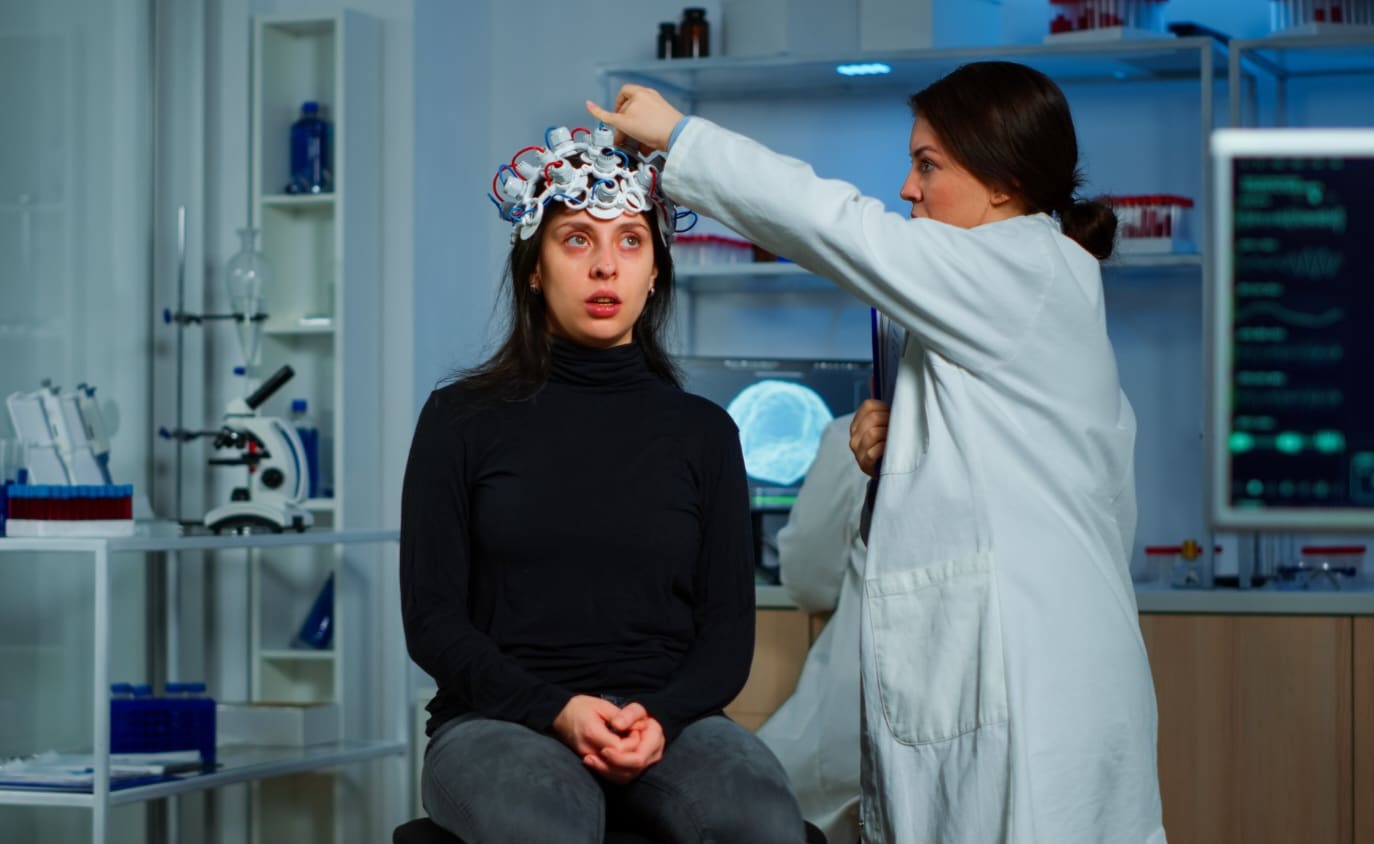 Doctor researcher adjusting eeg headset analyzing patient's evolution after