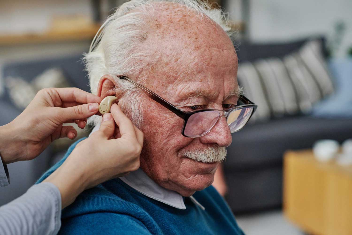 Closeup of caregiver wearing hearing aid