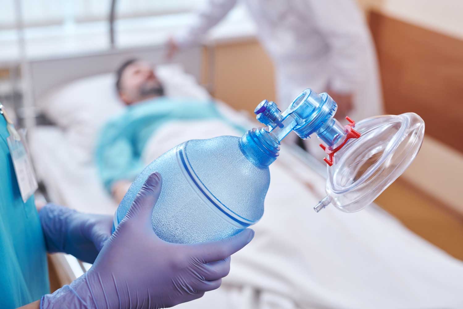 Close-up of unrecognizable nurse in gloves preparing oxygen mask