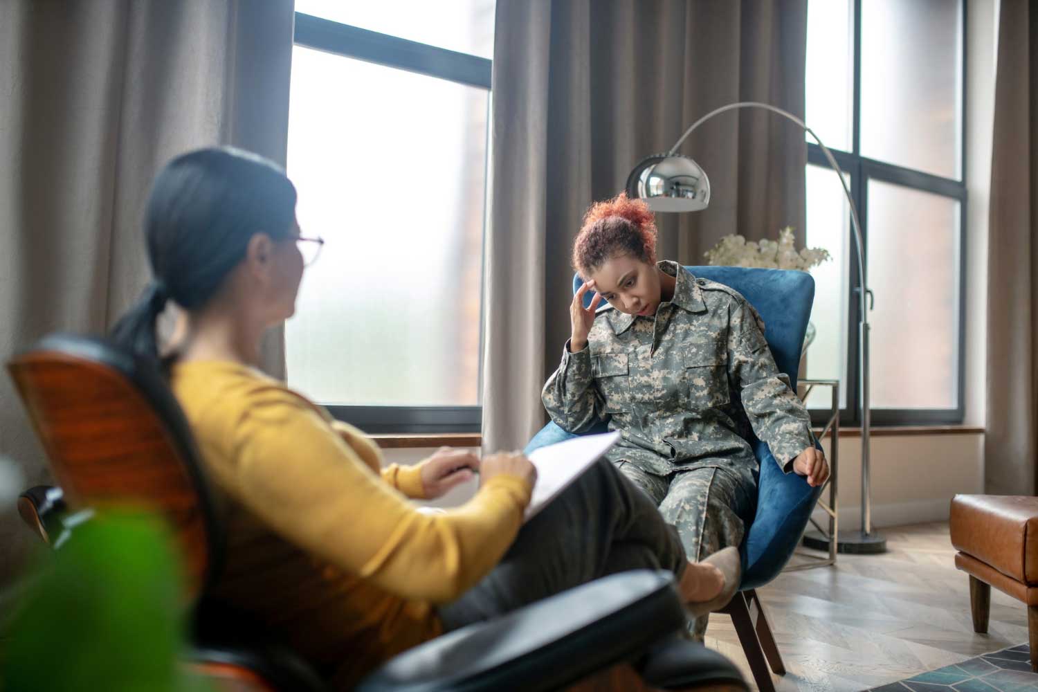 Young military woman talking to a psychotherapist