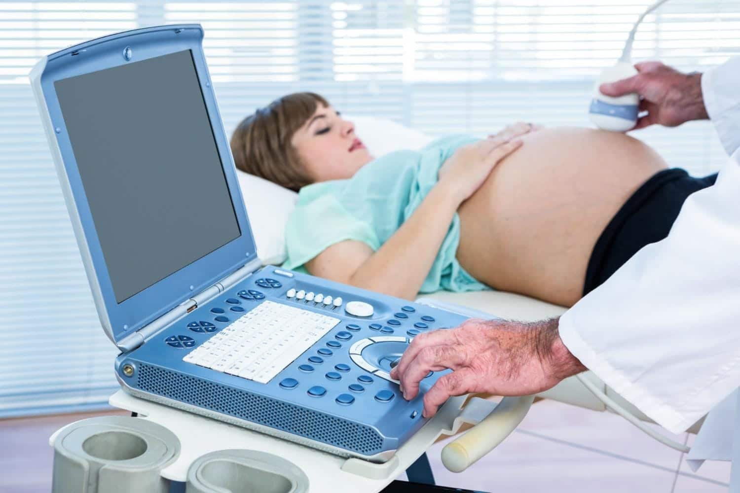 Image showing pregnant lady is undergoing Ultrasound.