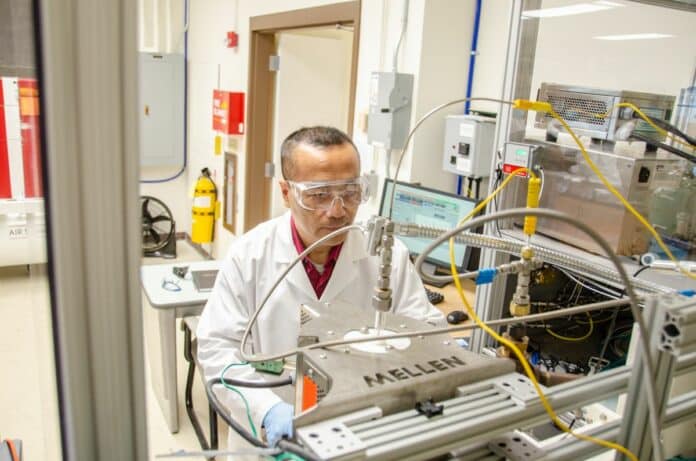 Chemical engineer John Hu operates a microwave reactor in his WVU lab.
