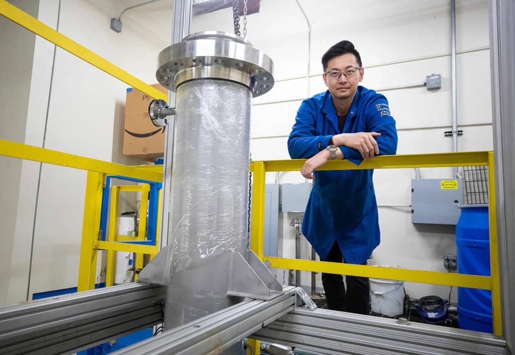 ​Charles Cai and a newly installed 20-gallon CELF reactor that will be used in the scale-up project.