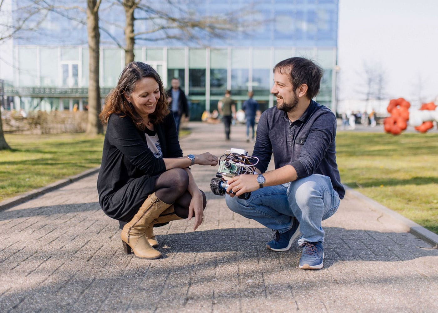 Elisabetta Chicca and Thorben Schoepe with a robot they designed to test their model of insect's navigation.