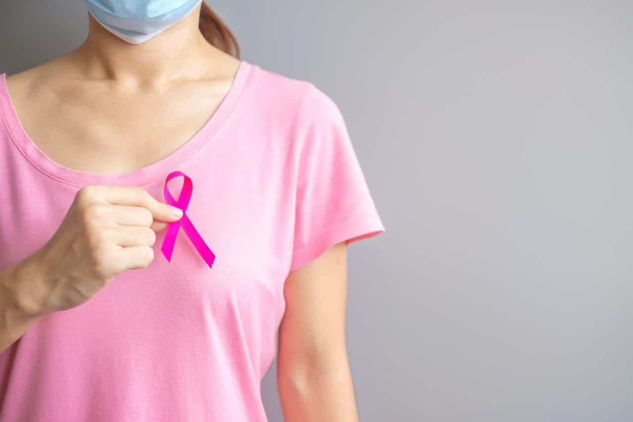 October Breast Cancer Awareness month, elderly Woman in pink T- shirt with hand holding Pink Ribbon for supporting people living and illness. International Women, Mother and World cancer day concept