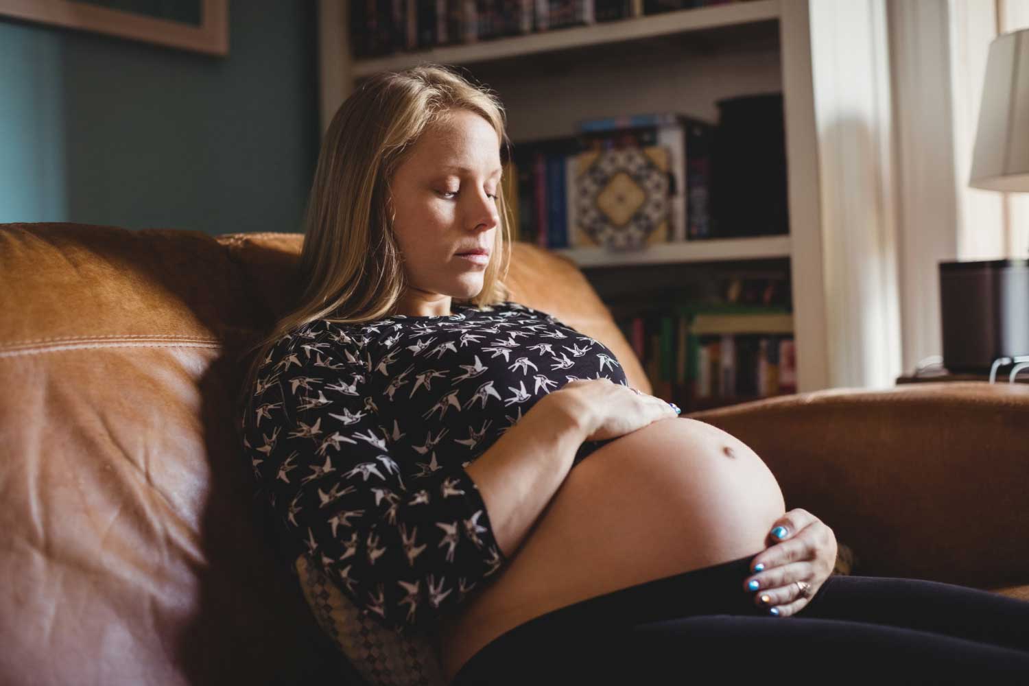 Pregnant woman relaxing in living room
