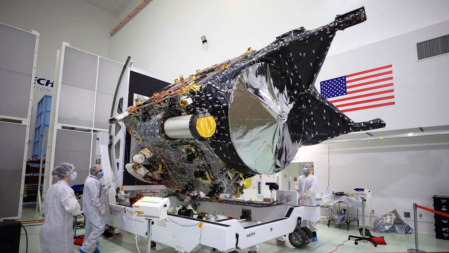 NASA’s Psyche spacecraft is shown in a clean room at the Astrotech Space Operations facility near the agency’s Kennedy Space Center in Florida on Dec. 8, 2022. DSOC’s gold-capped flight laser transceiver can be seen, near center, attached to the spacecraft.